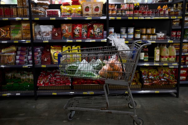 FILE - A shopping cart filled with groceries sits in an aisle at an Asian grocery store in Rowland Heights, Calif., Thursday, April 3, 2025. (AP Photo/Jae C. Hong, File)