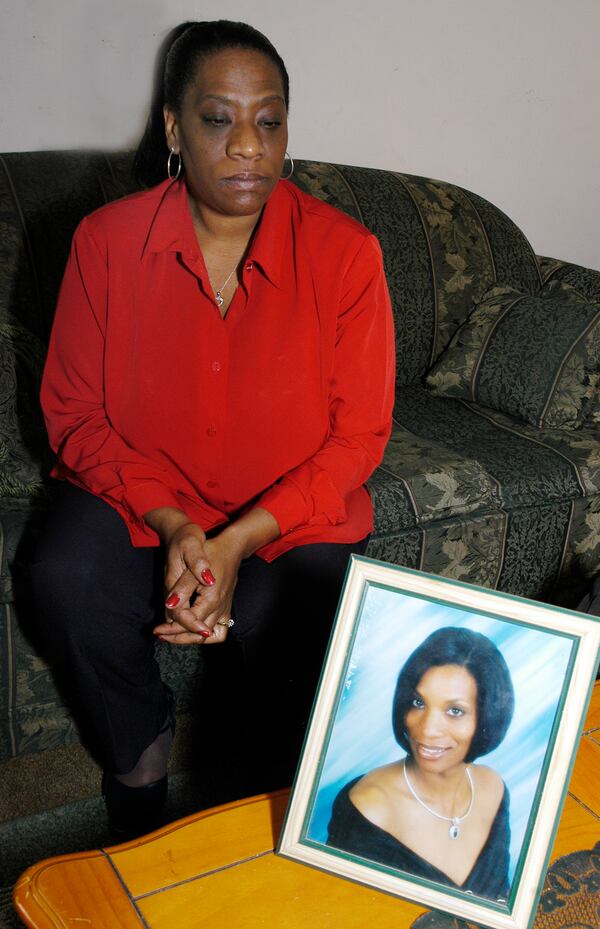 Lilburn: Roberta Adams  focuses on a portrait of her missing sister, Leslie Adams, who disappeared from her Lilburn apartment on October 21, 2005. Photo by Sarah Ianacone/Special