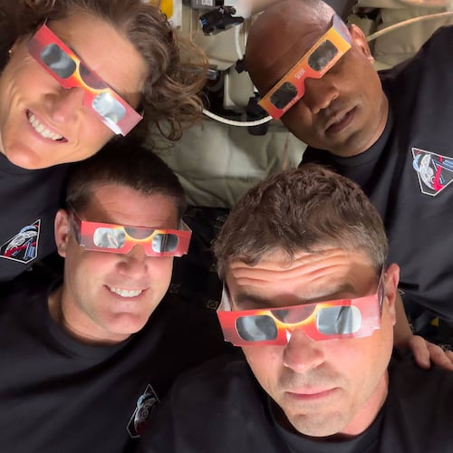 FILE - In this image provided by NASA the Artemis II crew, counterclockwise from top left, Mission Specialist Christina Koch, Mission Specialist Jeremy Hansen, Commander Reid Wiseman and Pilot Victor Glover pose with eclipse viewers during a lunar flyby on April 6, 2026. (NASA via AP, File)