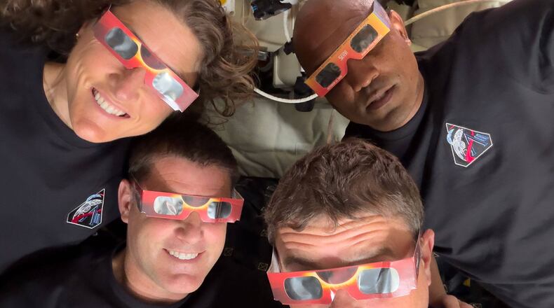 FILE - In this image provided by NASA the Artemis II crew, counterclockwise from top left, Mission Specialist Christina Koch, Mission Specialist Jeremy Hansen, Commander Reid Wiseman and Pilot Victor Glover pose with eclipse viewers during a lunar flyby on April 6, 2026. (NASA via AP, File)