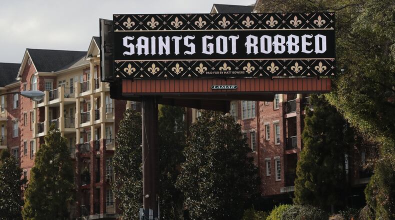 A digital billboard seen Tuesday on I-85 South at Peachtree Road in Atlanta reads “Saints Got Robbed” in reaction to the non-call on a pass interferance play by the Rams against the Saints in the NFC Championship Game . Curtis Compton/ccompton@ajc.com