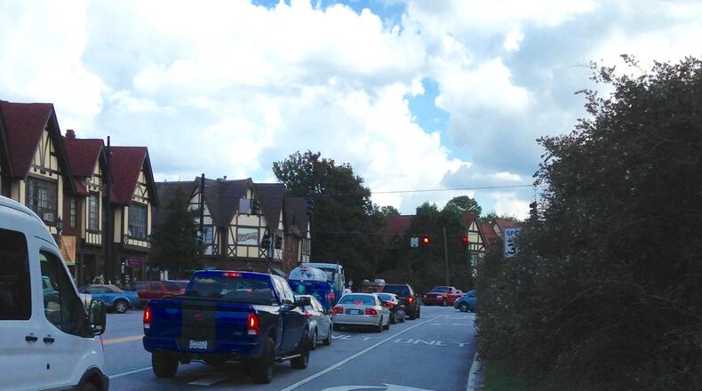 U.S. 278 in downtown Avondale Estates heading east during late afternoon rush hour. The Georgia Department of Transportation has agreed to let the city narrow this road from five to three lanes. The city’s iconic hedges, planted in the 1930s and separtating the commercial from residential districts, are on the right. Bill Banks file photo for the AJC