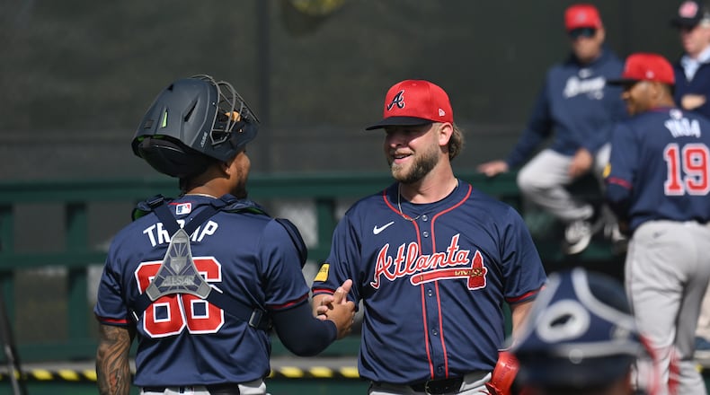 Atlanta Braves catcher Chadwick Tromp greets with relief pitcher A.J. Minter after they worked out in the bullpen during spring training workouts at CoolToday Park, Monday, Feb. 19, 2024, in North Port, Florida. (Hyosub Shin / Hyosub.Shin@ajc.com)