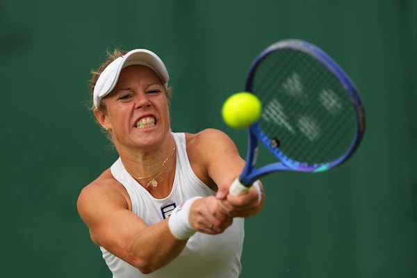 Laura Siegemund of Germany returns the ball to Solana Sierra of Argentina during their women's singles fourth round match at the Wimbledon Tennis Championships in London, Sunday, July 6, 2025.(AP Photo/Kirsty Wigglesworth)