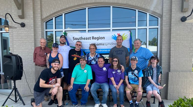 Employees and supporters gathered at Houck's Grille in May to raise funds for the Williams Syndrome Association. The Roswell restaurant regularly hosts events to support community organizations.