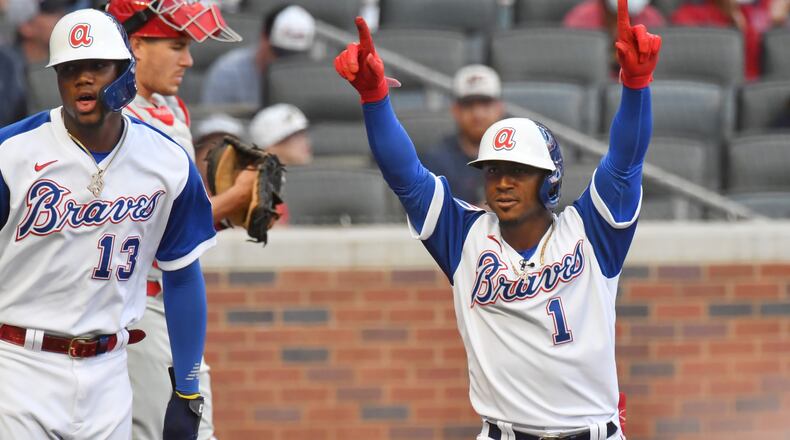 Braves second baseman Ozzie Albies (1) celebrates after hitting a two-run home run that scored Ronald Acuna (13) in the first inning Sunday, April 11, 2021, against the Philadelphia Phillies at Truist Park in Atlanta. (Hyosub Shin / Hyosub.Shin@ajc.com)