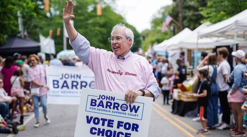 During an Atlanta festival parade in late April, Georgia Supreme Court candidate John Barrow donned a pink t-shirt emblazoned with the words “Empowering Women” and carried a “Vote For Choice” campaign sign. He doubled down on his abortion rights message a few days later during an Atlanta Press Club candidate debate, when he criticized his opponent, Justice Andrew Pinson, for defending Georgia’s anti-abortion law. (Elijah Nouvelage for The Atlanta Journal-Constitution)