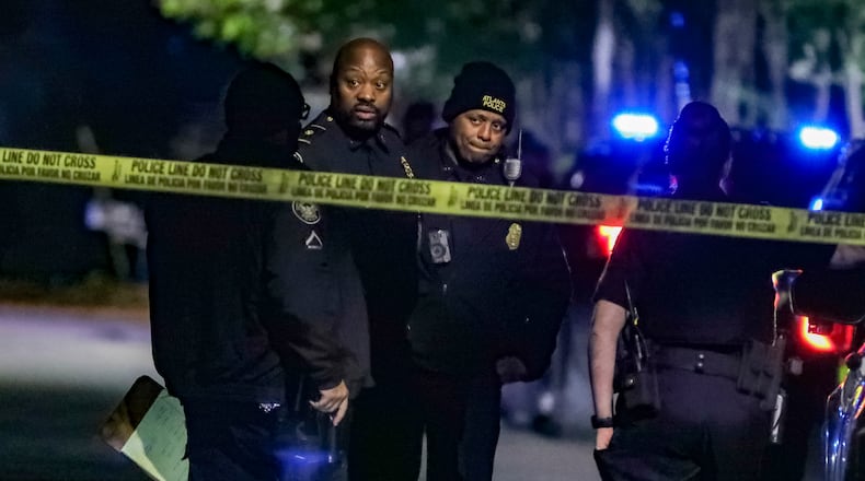 Atlanta homicide investigators work at the scene of an October shooting on Highview Road in the Beecher Hills neighborhood and found a 57-year-old woman with a gunshot wound to her body. She was transported to Grady Memorial Hospital, where she died. (John Spink / John.Spink@ajc.com)