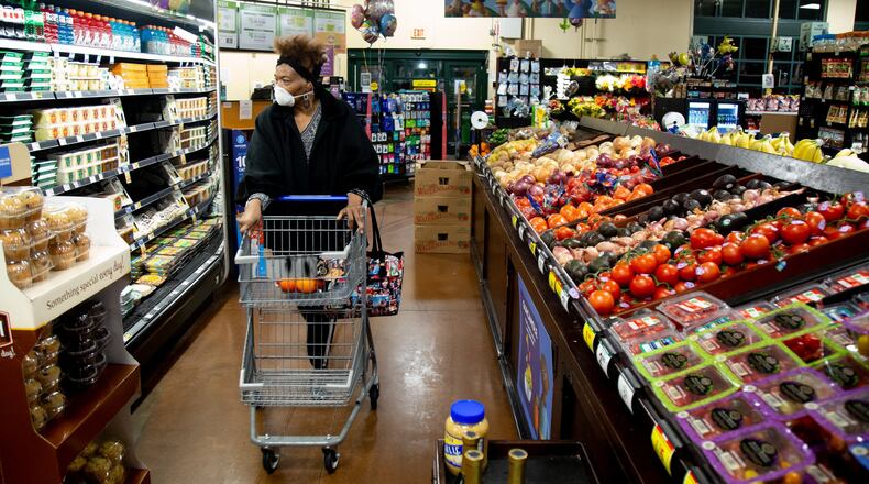 Martha Allen protects herself with a mask while grocery shopping in Decatur on March 23 2020. STEVE SCHAEFER / SPECIAL TO THE AJC