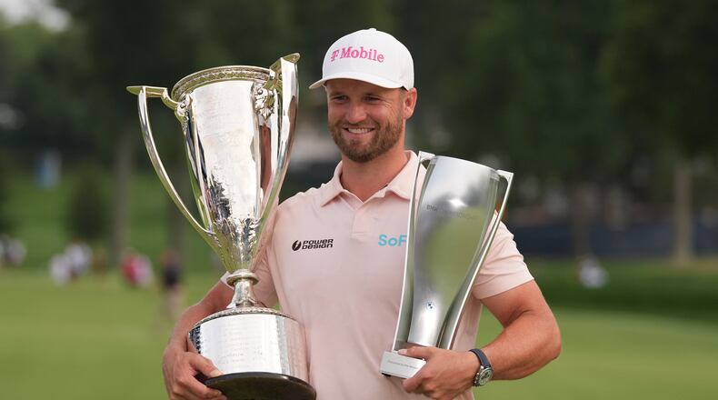Wyndham Clark holds the Wanamaker Trophy and the BMW trohy after winning the BMW Championship golf tournament, Sunday, Aug. 23, 2026, in St. Louis. (AP Photo/Jeff Roberson)