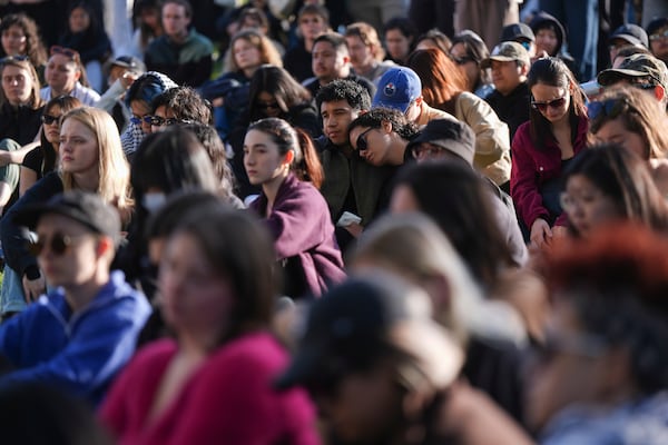 People listen to community members speak during a vigil for the victims after a vehicle drove into a crowd Saturday and killed multiple people at a Filipino heritage festival, in Vancouver, British Columbia, Sunday, April 27, 2025. (Darryl Dyck/The Canadian Press via AP)