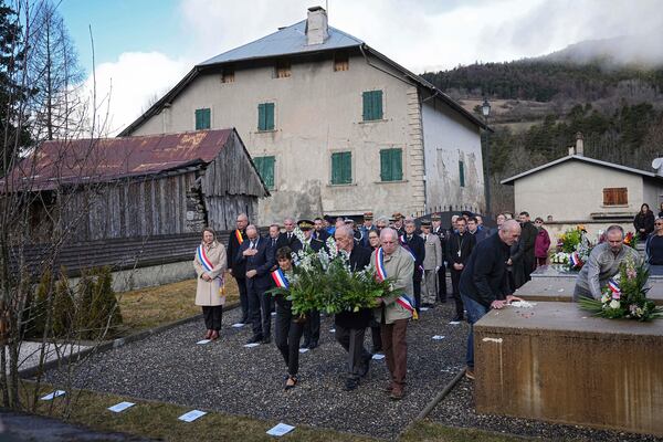 Local authorities lay flowers at the cemetery during a memorial ceremony, 10 years after the Germanwings plane crash, Monday, March 24, 2025 in Le Vernet, southern France. (AP Photo/Laurent Cipriani)