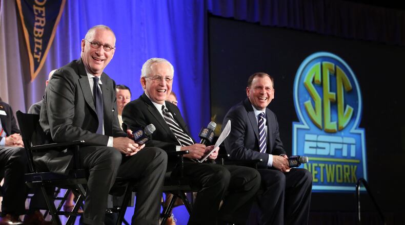 ESPN president John Skipper, left, SEC commissioner Mike Slive, center, and ESPN Senior Vice President of Programing Justin Connolly answer questions from media.