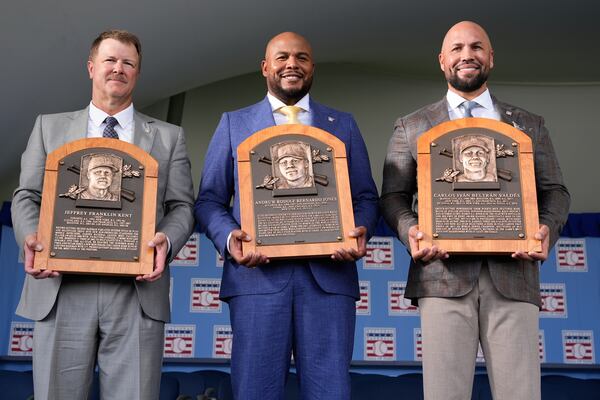 Inductees (from left) Jeff Kent, Andruw Jones and Carlos Beltran pose for pictures after their ceremony in Cooperstown, N.Y. (Seth Wenig/AP)