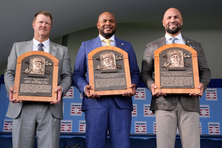 The 2026 Baseball Hall of Fame inductees Jeff Kent, left, Andruw Jones, center, and Carlos Beltran pose for pictures after the induction ceremony in Cooperstown, N.Y., Sunday, July 26, 2026. (AP Photo/Seth Wenig)