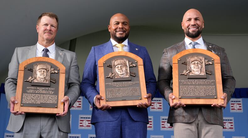 The 2026 Baseball Hall of Fame inductees Jeff Kent, left, Andruw Jones, center, and Carlos Beltran pose for pictures after the induction ceremony in Cooperstown, N.Y., Sunday, July 26, 2026. (AP Photo/Seth Wenig)