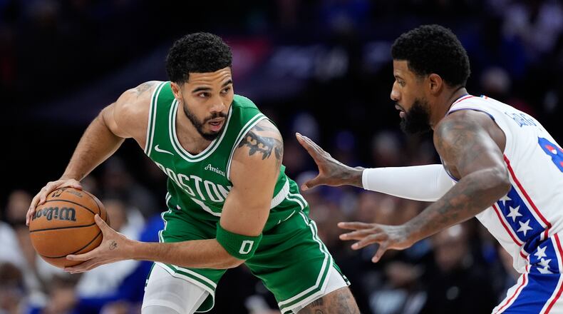 Boston Celtics' Jayson Tatum, left, tries to get past Philadelphia 76ers' Paul George during the first half of Game 6 in a first-round NBA basketball playoff series Thursday, April 30, 2026, in Philadelphia. (AP Photo/Matt Slocum)