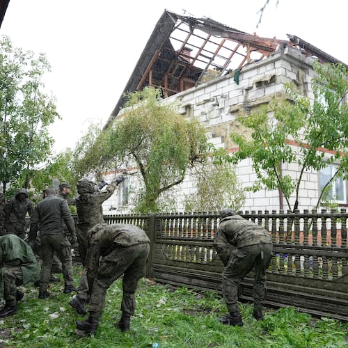 FILE - Territorial defense officers clean up debris from the destroyed roof of a house in Wyryki near Lublin, Poland, after Russian drones violated Polish airspace during an attack on Ukraine, on Sept. 11, 2025. (AP Photo/Czarek Sokolowski, File)
