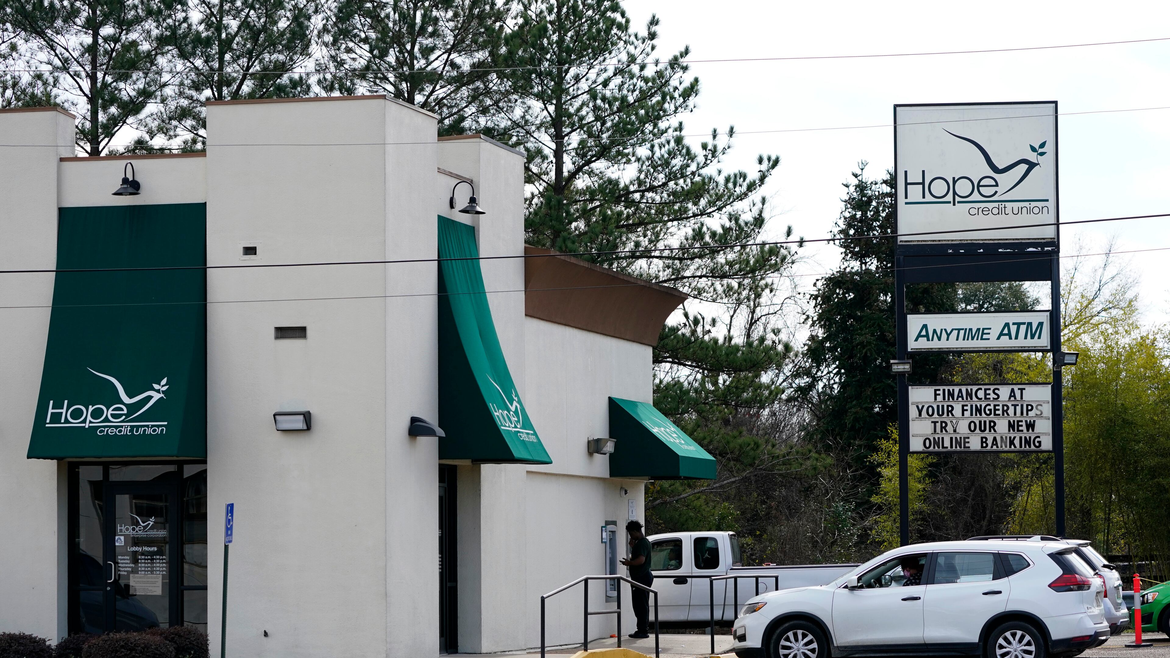 A customer uses an outdoor ATM at a Hope Credit Union branch in Jackson, Miss., Monday, Feb. 8, 2021. Hope Credit Union is merging with Atlanta-based 1st Choice Credit Union. (Rogelio V. Solis/AP)