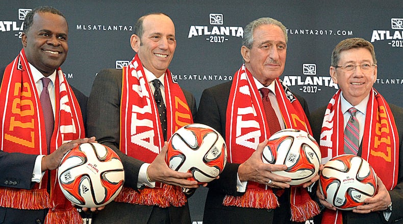 April 16, 2014 Atlanta - Atlanta mayor Kasim Reed (from left), MLS commissioner Don Garber, Falcons owner Arthur Blank and executive director of GWCC Frank Poe pose for a group photograph after the official announcement event in downtown Atlanta on Wednesday, April 16, 2014. MLS commissioner Don Garber, Falcons owner Arthur Blank, mayor Kasim Reed, executive director of GWCC Frank Poe and others officially announced that Atlanta will be the 22nd team in MLS on Wednesday downtown amidst a parade-like atmosphere. HYOSUB SHIN / HSHIN@AJC.COM