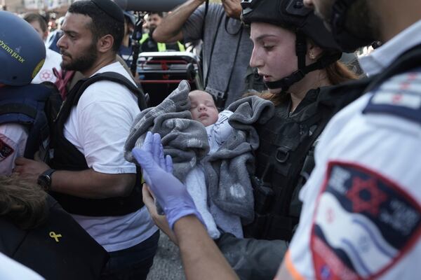 A baby is evacuated from the site of a direct hit from an Iranian missile strike in Ramat Gan, Israel, Thursday, June 19, 2025. (AP Photo/Oded Balilty)
