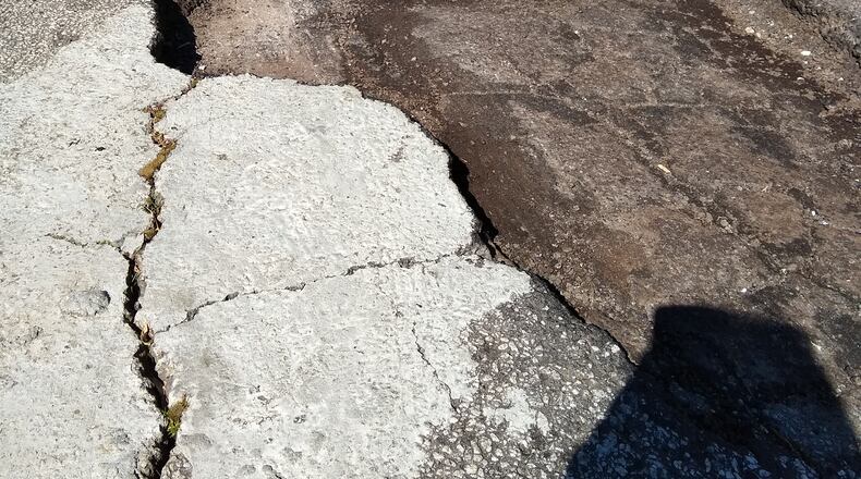 Claire Potvin hopes this giant pothole will soon be fixed. Photo/Claire Potvin.