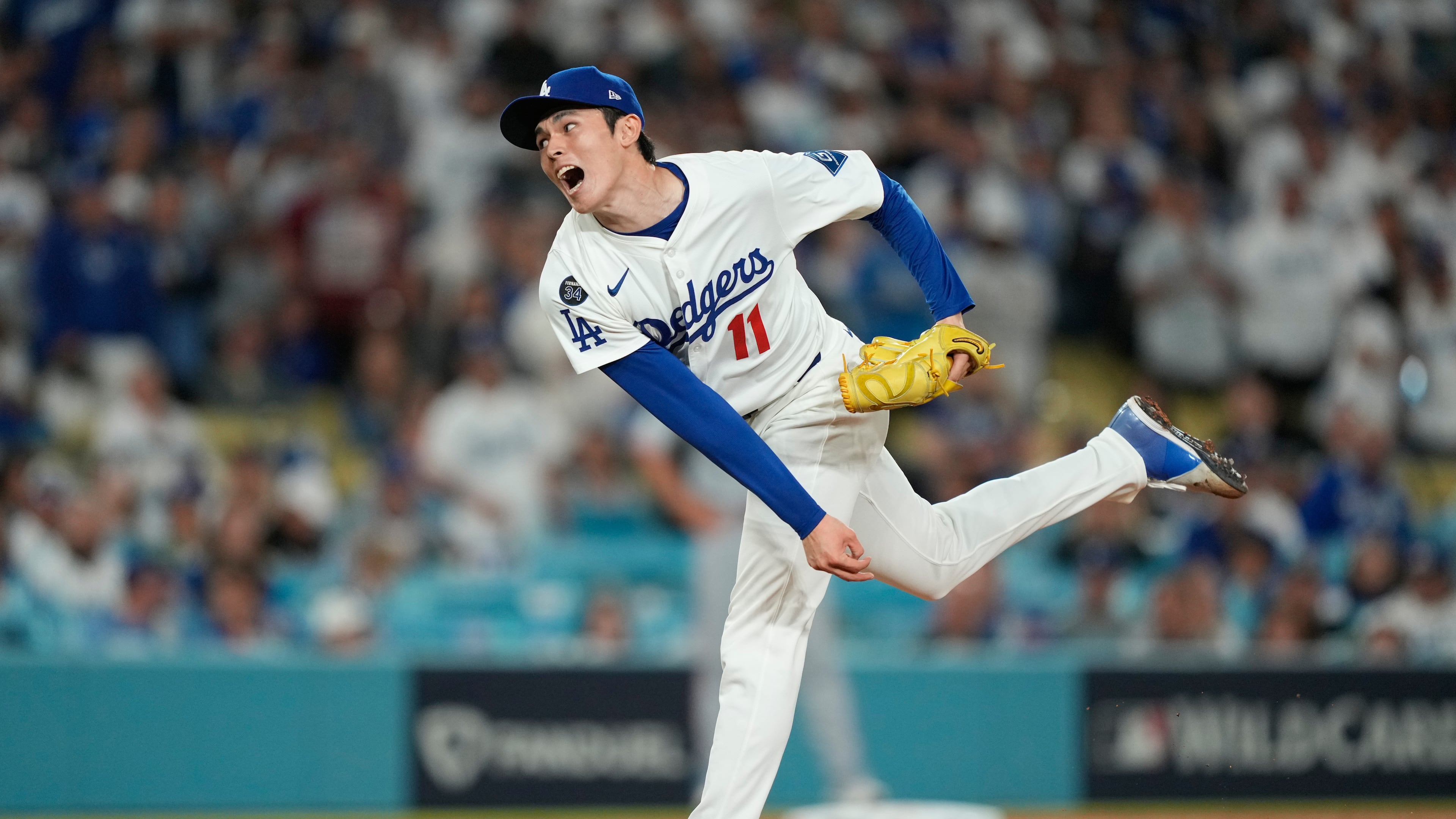 Los Angeles Dodgers relief pitcher Roki Sasaki throws to a Cincinnati Reds batter during the ninth inning in Game 2 of the National League Wild Card baseball playoff series Wednesday, Oct. 1, 2025, in Los Angeles. (AP Photo/Mark J. Terrill)