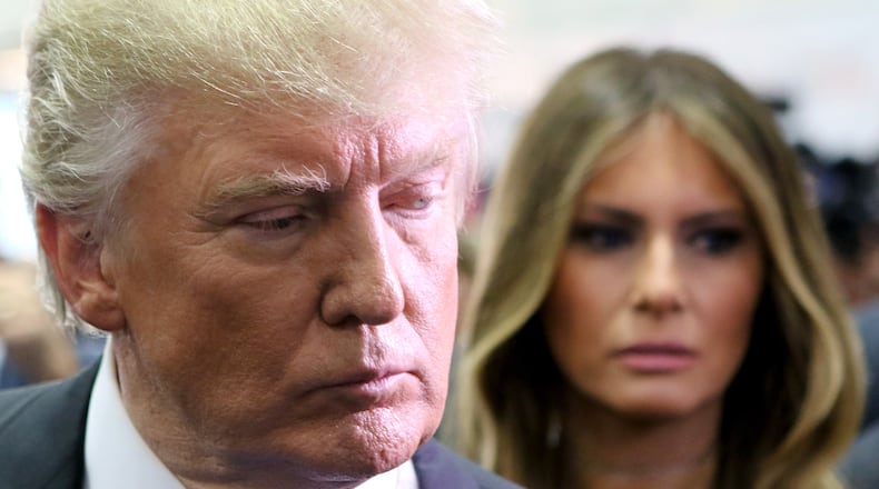 HEMPSTEAD, NY - SEPTEMBER 26: Republican president-elect Donald Trump speaks to the media in the spin room as wife, Melania Trump (R) looks on during the Presidential Debate at Hofstra University on September 26, 2016 in Hempstead, New York. (Photo by Michael Bocchieri/Getty Images)