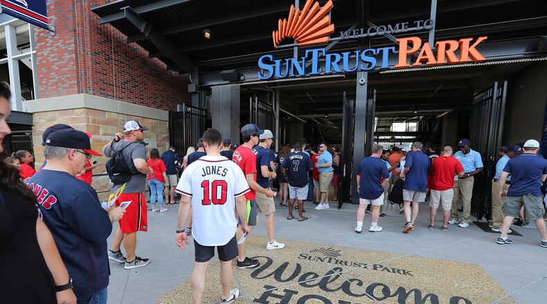 Fans enter the third base gate for the Braves home opener in their new stadium at SunTrust Park on Friday, April 14, 2017, in Atlanta. CURTIS COMPTON/CURTIS.COMPTON@AJC.COM
