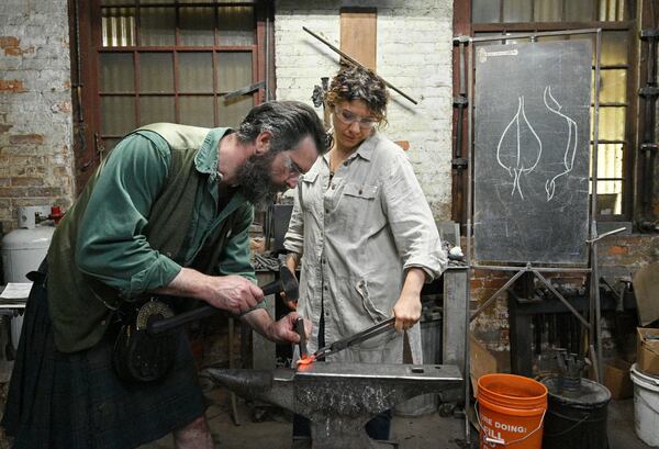 Mark Johnstone Hopper (left) works on a leaf as his partner Jessica Collins helps at the studio, Goat n Hammer. Hyosub Shin / Hyosub.Shin@ajc.com