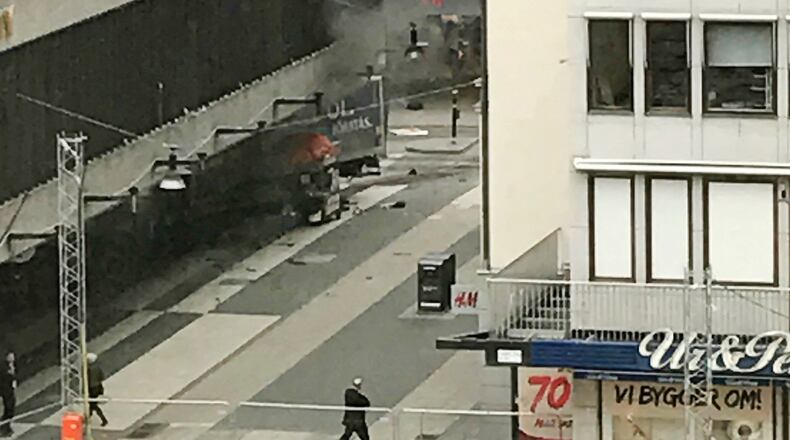 People look on at the scene after a truck crashed into a department store injuring several people in central Stockholm, Sweden, Friday April 7, 2017. (Andreas Schyman, TT News Agency via AP)