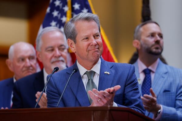 Gov. Brian Kemp claps during a speech before he signs a series of education bills at the Capitol in May, including a school literacy bill. The bills provide training and support for educators, requires screening for dyslexia and other learning disabilities and mandates kindergarten attendance. (Arvin Temkar/AJC)