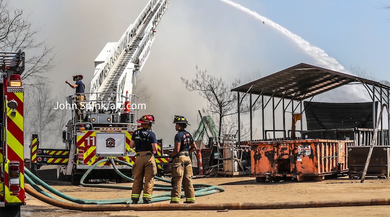 Fire crews shut down a busy intersection in southeast Atlanta to battle a blaze at a metal salvage yard.