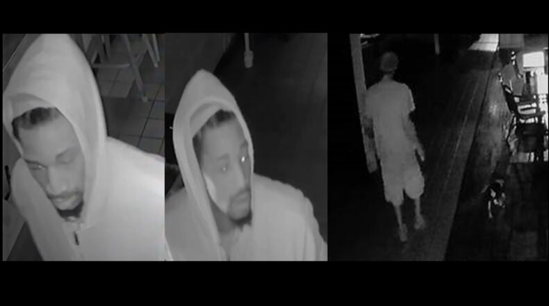A burglary suspect is seen on surveillance footage walking a small dog in a bar that was robbed.