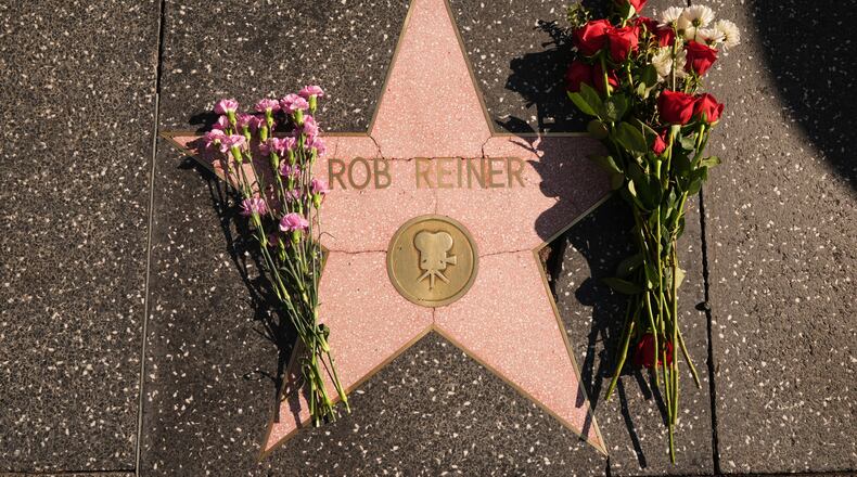 Flowers cover the Walk of Fame star for Rob Reiner Monday, Dec. 15, 2025, in the Hollywood section of Los Angeles. (AP Photo/Damian Dovarganes)