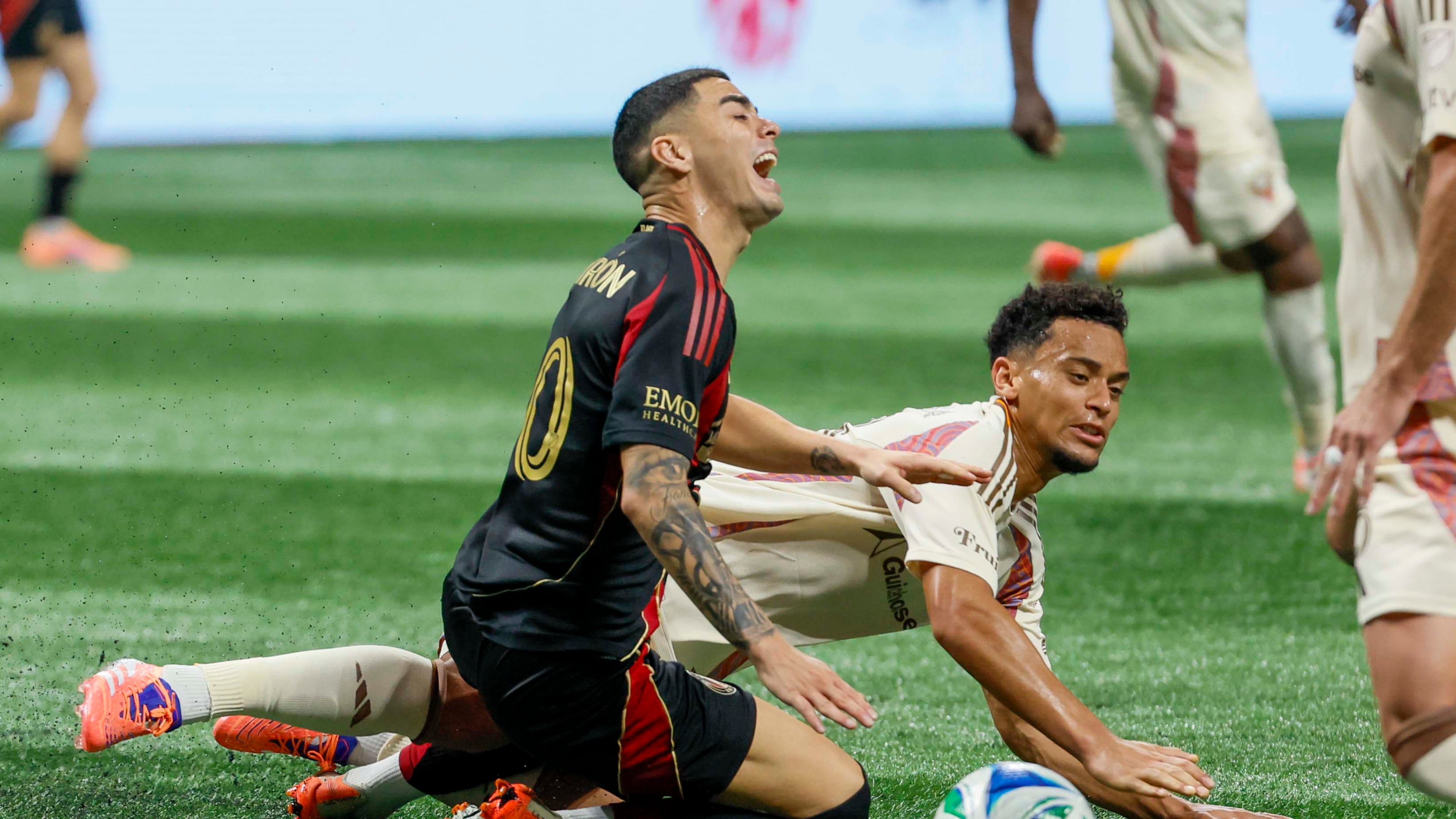 Midfielder Miguel Almirón (center, kneeling) — pictured reacting to a foul against D.C. United on Oct. 18 — was fourth on the list of highest salaries in MLS at $7.9 million behind Inter Miami's Lionel Messi ($20.4M), LAFC's Son Heung-min ($11.1M) and Miami's Sergio Busquets ($8.8M). (Miguel Martinez/AJC)