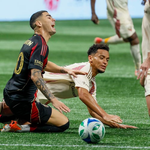 Midfielder Miguel Almirón (center, kneeling) — pictured reacting to a foul against D.C. United on Oct. 18 — was fourth on the list of highest salaries in MLS at $7.9 million behind Inter Miami's Lionel Messi ($20.4M), LAFC's Son Heung-min ($11.1M) and Miami's Sergio Busquets ($8.8M). (Miguel Martinez/AJC)