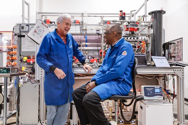 JTEC Energy CEO Mike McQuary (left) shares a laugh with company founder and inventor Lonnie Johnson at their headquarters in Atlanta. A trained nuclear engineer, Johnson served in the Air Force and later worked on NASA’s Galileo mission. (Natrice Miller/AJC)