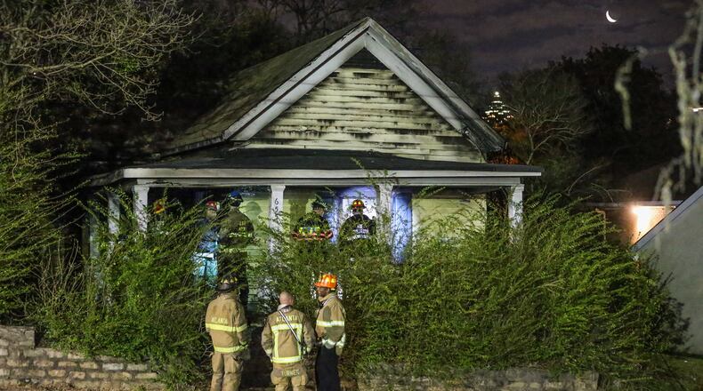 Authorities investigate a fire that left a baby dead and a woman critically burned in northwest Atlanta. JOHN SPINK/ JSPINK@AJC.COM