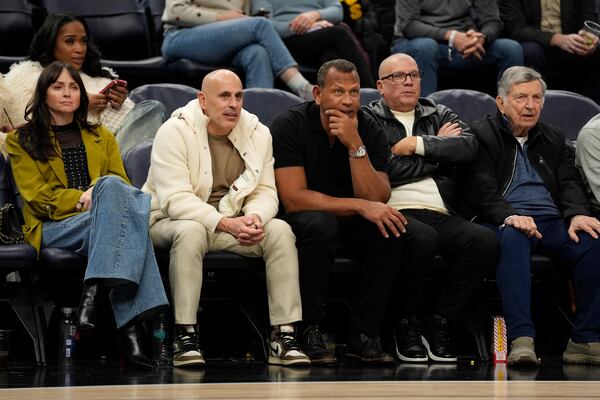 FILE - Minnesota Timberwolves minority owners Marc Lore, middle left, and Alex Rodriguez, middle right, watch during the second half of an NBA basketball game against the New York Knicks, Dec. 19, 2024, in Minneapolis. (AP Photo/Abbie Parr, File)