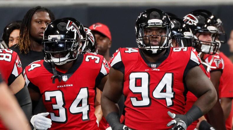 Atlanta Falcons cornerback Brian Poole (34) and Atlanta Falcons defensive tackle Deadrin Senat (94) take the field for pregame warmups. The Atlanta Falcons played the New Orleans Saints in an NFL football game Sunday, Sept 23, 2018, at Mercedes-Benz Stadium in Atlanta, GA. BOB ANDRES /BANDRES@AJC.COM