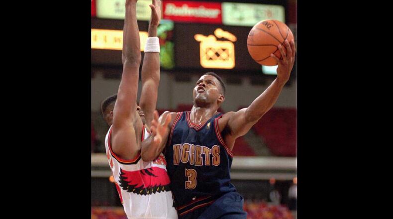 Dale Ellis (3) of the Denver Nuggets goes up against Ivano Newbill (28) of the Atlanta Hawks in 1996.