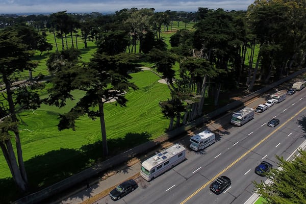 Motorists travel past RVs parked on Lake Merced Boulevard in San Francisco, Tuesday, July 15, 2025. (AP Photo/Godofredo A. Vásquez)