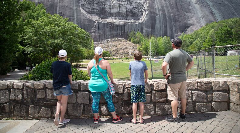 A family looks at the Confederate Memorial Carving at Stone Mountain Park Sunday, May 17, 2020.  STEVE SCHAEFER FOR THE ATLANTA JOURNAL-CONSTITUTION