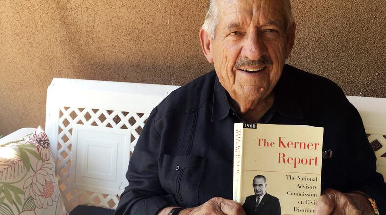 In this Aug. 31, 2017, photo, former U.S. Sen. Fred Harris of Oklahoma holds a copy of “The Kerner Report” at his home in Corrales, N.M., as he discusses the 50th anniversary of the Kerner Commission, a panel appointed by President Lyndon Johnson in 1967 to examine the causes of the 1960s riots. Harris is the last surviving member of the Kerner Commission, and he says he remains haunted that its recommendations on U.S. race relations and poverty were never adopted. AP PHOTO / RUSSELL CONTRERAS