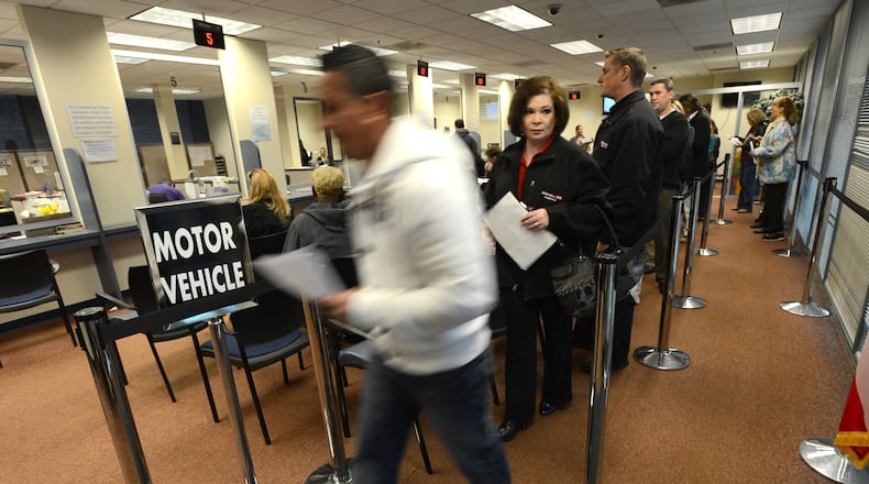Hector Amador of Roswell makes a visit to the Fulton County Tag Office in Alpharetta. Starting today, Georgia drastically changes the way it taxes motor vehicle titles.