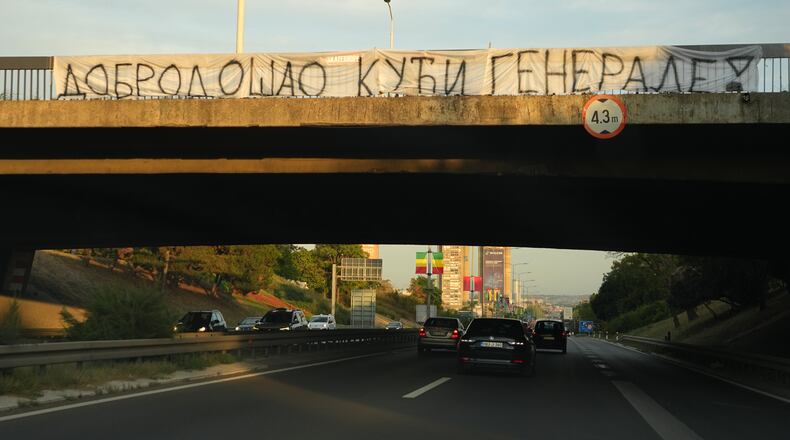 Cars move along under a bridge with a banner on it reading: "Welcome home, General! (former Bosnian Serb wartime general Ratko Mladic)" in Belgrade, Serbia, Thursday, Sept. 3, 2026. (AP Photo/Darko Vojinovic)