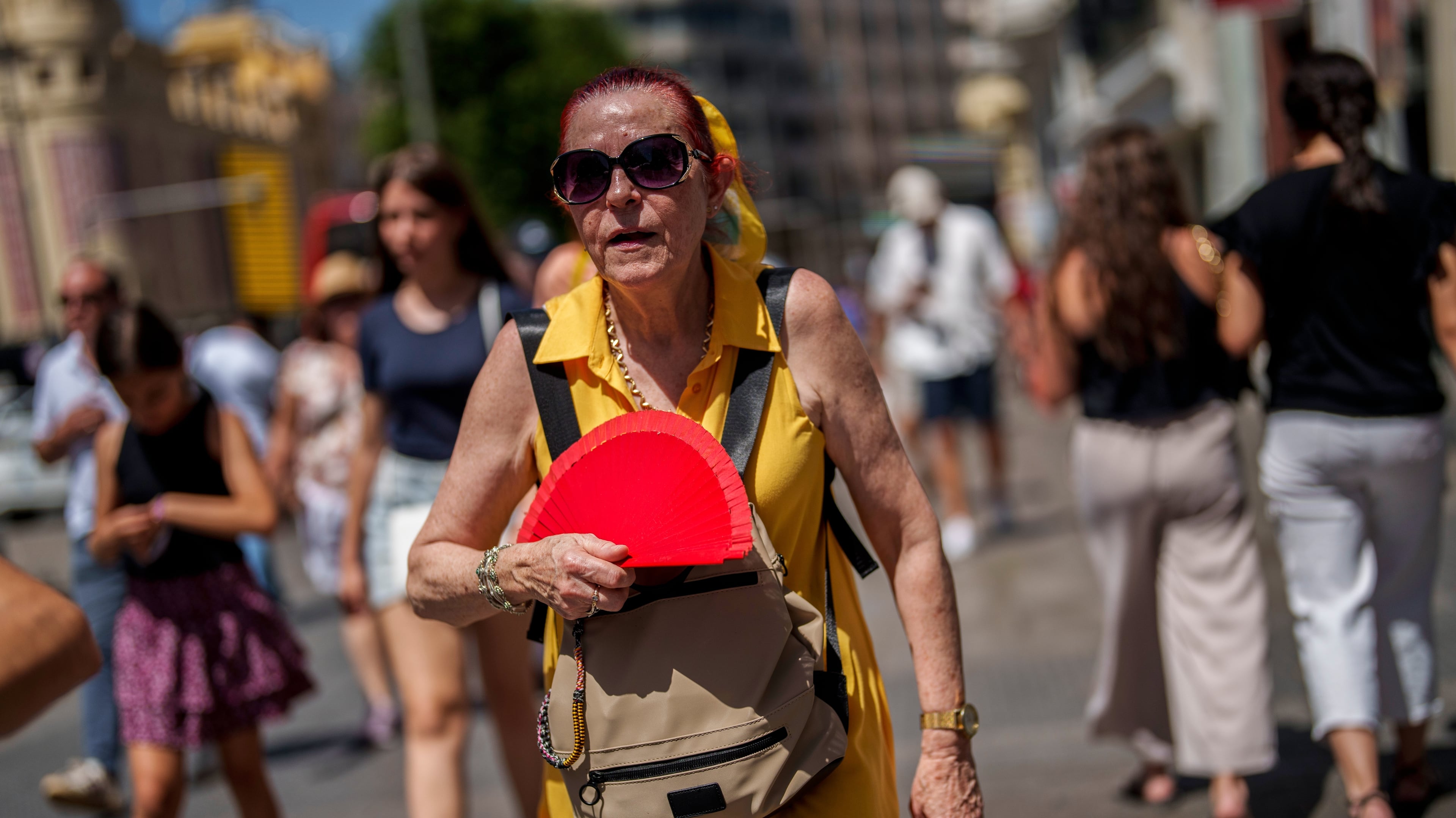 FILE - A woman fans herself in Madrid, Spain, July 10, 2023. (AP Photo/Manu Fernandez, File)
