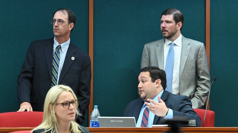 State ethics commission members (clockwise from left) James Kreyenbuhl, commission vice chair, Robert Watts, and David Emadi, executive secretary, talk during a recess at an ethics commission meeting. (Hyosub Shin / Hyosub.Shin@ajc.com)