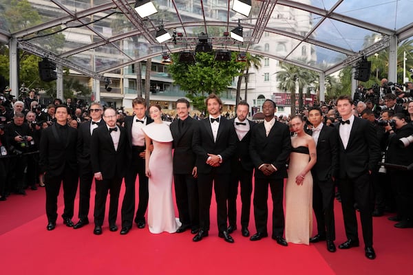 Clifton Collins Jr., from left, Joaquin Phoenix, director Ari Aster, Austin Butler, Emma Stone, Pedro Pascal, Luke Grimes, producer Lars Knudsen, Micheal Ward, Amelie Hoeferle, Matt Gomez Hidaka and Cameron Mann pose for photographers upon arrival at the premiere of the film 'Eddington' at the 78th international film festival, Cannes, southern France, Friday, May 16, 2025. (AP Photo/Natacha Pisarenko)